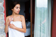 © Kike Arnaiz/ADDICTIVE STOCK - Young woman wrapped in towel while standing at balcony entrance