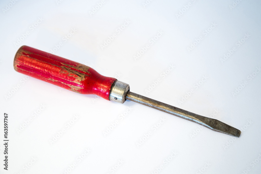 Vintage screwdriver with the red rubber handles, isolated on white background