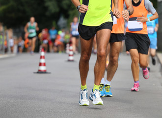 Wall Mural - athletes run the marathon on the city road