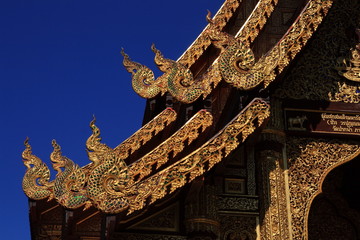 gable of temple in northern region Thailand

artistic wood crafted detail decoration on temple gable northern region Thailand style.
