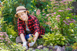 © alter_photo - woman gardener planting flowers
