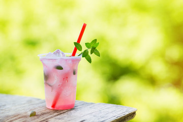 Wall Mural - Lemonade with ice and mint in the fresh air. Selective focus.