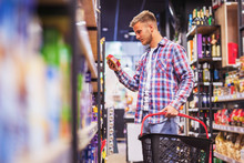 Young Man Shopping In A Supermarket Holding Shopping Cart