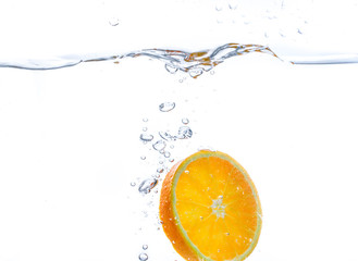 orange slice in water splash. white  background