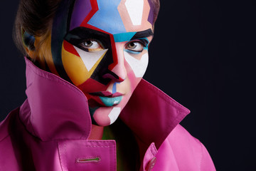 Model with a creative pop art makeup on her face.