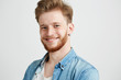 © Cookie Studio - Portrait of young sincere attractive guy smiling looking at camera over white background.