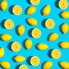 Wall Mural - Fresh lemon pattern on a vivid blue background flat lay