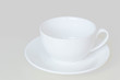 White cup and saucer for tea or coffee isolated on a light background.