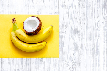 Appetizing cocount, banana on wooden table background top view copyspace