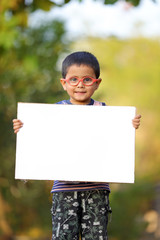 Indian child on eyeglass holding white board in hand