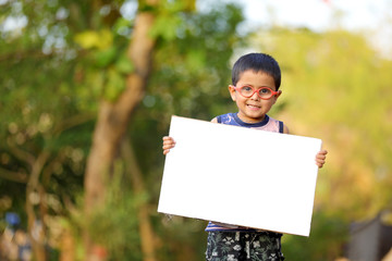 Indian child on eyeglass holding white board in hand