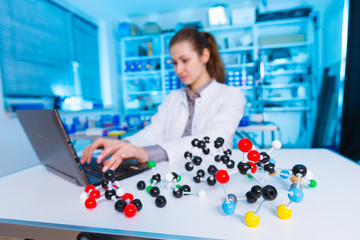 Canvas Print - Young woman laboratory assistant in scientifics laboratory with model of molecule..Student girl in chemical class