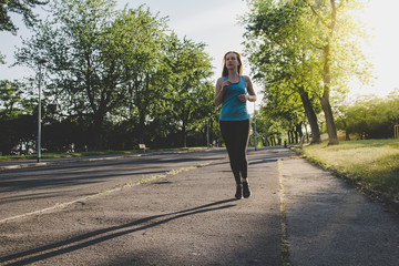  Young woman running, jogging in the park. Exercising outdoor
