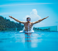 Young, Muscular Swimmer Splashing Water