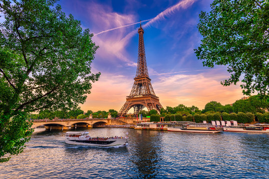 paris eiffel tower and river seine at sunset in paris, france. eiffel tower is one of the most iconi