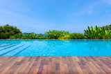 Fototapeta  - Swimming pool overlooking view andaman sea mountains and blue sky background,summer holiday background concept.