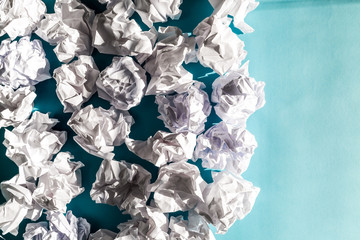 Crumpled paper balls on a blue background