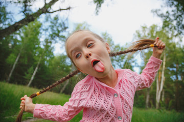 Very playful little girl jokingly stuck out her tongue.