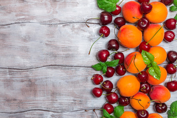  Apricots and cherries on rustic  background