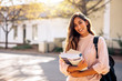 © Jacob Lund - Female college student with books outdoors
