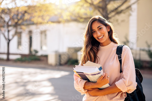 Fotografía Female college student with books outdoors