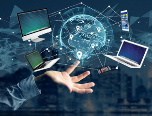 Computer and devices displayed on a futuristic interface with interantional network - Multimedia and technology concept