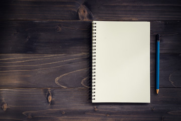 Office wood table with blank notepad, pencil.