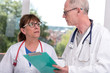 © thodonal - Two doctors discussing about medical report