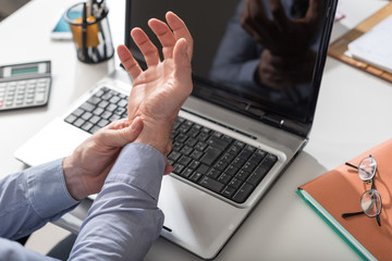 Businessman suffering from wrist pain