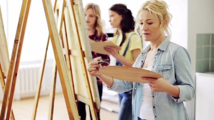 Wall Mural - students with easels painting at art school