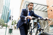 © Sergey Nivens - Young businessmen with a bike