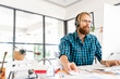 © Sergey Nivens - Young man working in office