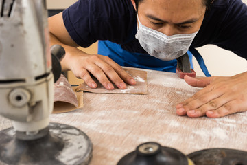 the man worker carpenter polishing a wooden board for painted