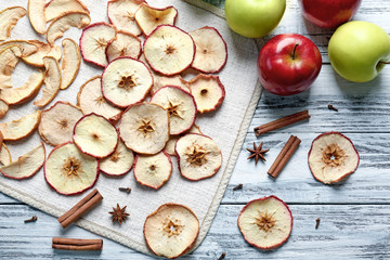 Wall Mural - Composition with apple chips and cinnamon on wooden table