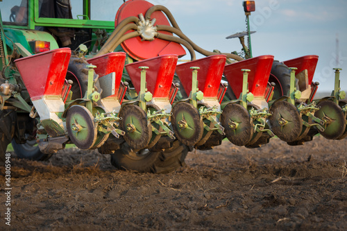 Fotografie, Obraz Seeder for sowing attached to tractor on soil