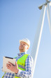 © 123object_stock - young engineer is checking on wind turbine energy production