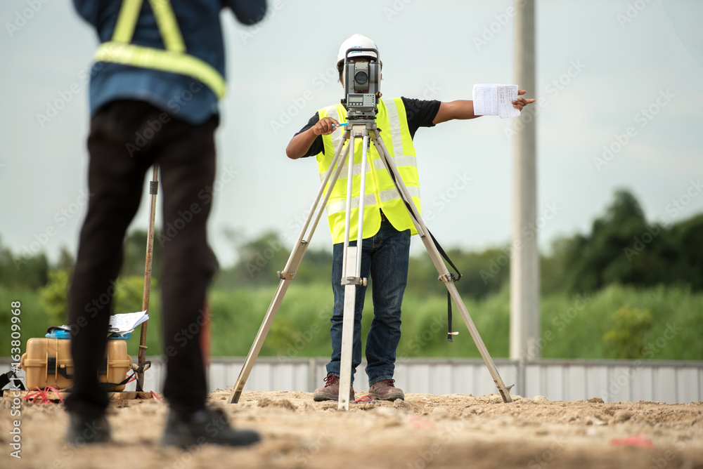 survey engineer in construction site use theodolite mark a concrete pile co ordinate  - obrazy, fototapety, plakaty 
