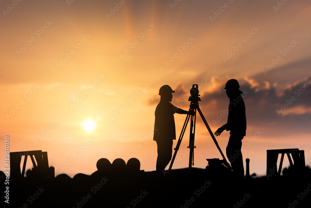 silhouette workers on background of construction - obrazy, fototapety, plakaty 