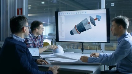 Team of Industrial Engineers Discuss 3D Turbine/ Engine Part Design Shown on a Presentation Display. In the Background Factory is Seen.Shot on RED EPIC-W 8K Helium Cinema Camera.