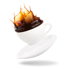 Wall Mural - Coffee splashing out of a cup isolated on white background.