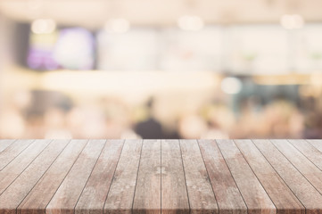 Wood table top and blurred restaurant kitchen interior background - can used for display or montage your products.