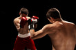 © master1305 - Two professional boxer boxing on black background,