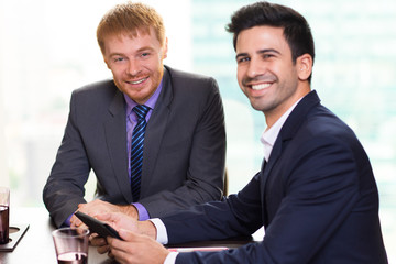 Wall Mural - Positive male colleagues working together