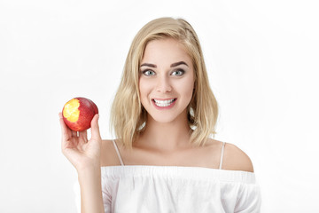 Canvas Print - Portrait of blond woman with white teeth eating fresh nectarine. female smile