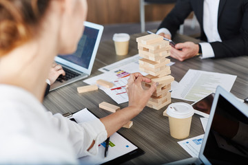 Team of business people build a wooden construction. concept of teamwork and partnership