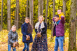 © satura_ - Family, autumn, happiness and people concept - mother, father, son and daughter playing in autumn park