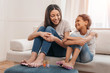 © LIGHTFIELD STUDIOS - Happy african american mother and daughter doing pedicure together at home