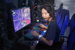 © OHishi_Foto - young girl playing computer game on line in internet cafe