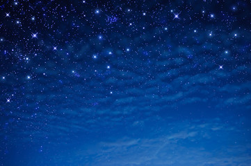 Wall Mural - stars in the blue sky at night with clouds