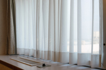 sunshire light looking pass Translucent white fabric curtains and window glass fame and view outdoor background